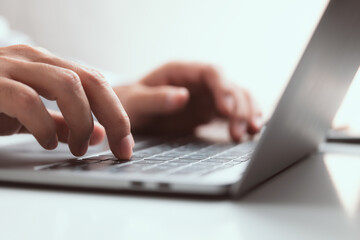 Close-up of Male hand  typing laptop keyboard.