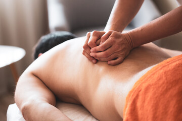 Man having a back massage in massage salon