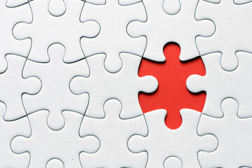 Red jigsaw puzzle pieces on red background. Copy space and business concept