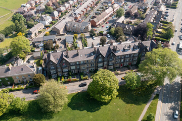 Aerial drone photo of the beautiful historical town of Harrogate, North Yorkshire in the UK showing the residential housing estates and rows of houses from above in the summer time - obrazy, fototapety, plakaty