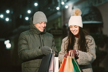 Young couple outdoor in night street at christmas time