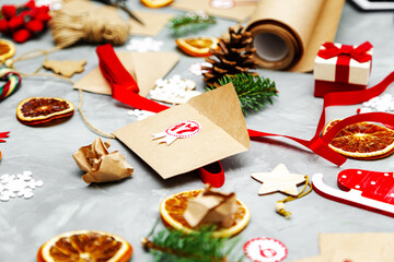 Fototapeta na wymiar Preparing the Advent Calendar. Eco craft envelopes with gifts for children.