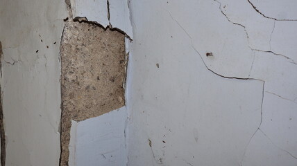 Cement wall collapse. Cracked concrete old wall. dangerous, damaged building structure.