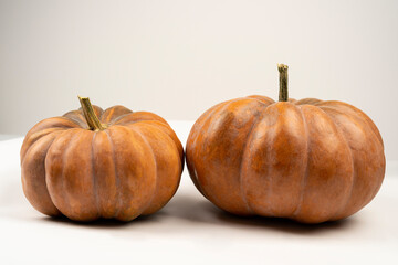 Two high resolution pumpkins isolated on a white background