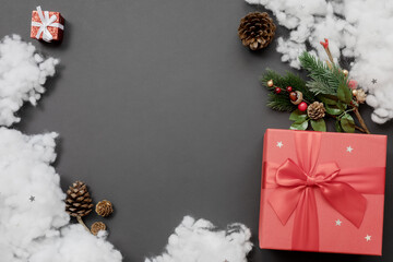 Christmas composition of red gift boxes with fir branches and cones and artificial snow. Layout