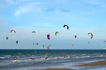 Kitesurfer with colorful Power kites at the beach of Wissant, Kiteboarding, Plage de Wissant, Cote de Opal, Pas-de-Calais, Hauts-de-France, France