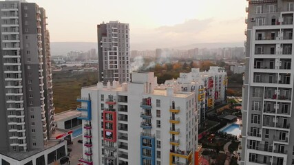 Tbilisi, Georgia - 17th october, 2021: Aerial close up drone backwards shot flying in residential apartment buildings and commercial property in urban north Tbilisi neighborhood in caucasus, Georgia
