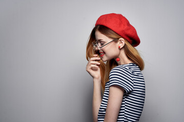 cheerful woman in a striped t-shirt red lips gesture with his hands lifestyle