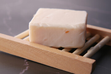 Homemade natural soap bar on black background 