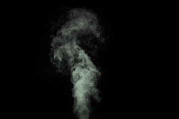 Fragment of green gray hot curly steam smoke isolated on a black background. Create mystical Halloween photos.