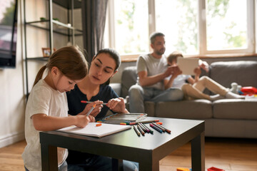 Young family relax with hobby activity at home