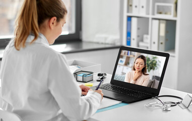 healthcare, technology and medicine concept - female doctor having video call with sick woman patient on laptop computer at hospital - obrazy, fototapety, plakaty