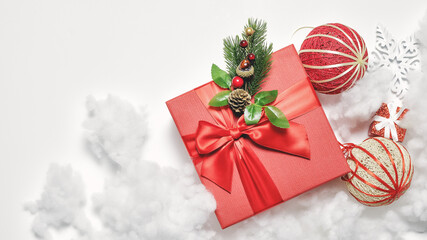 Beautiful Christmas composition with gift box, decorations and artificial snow. Elegant greeting card. Background banner. Festive mockup