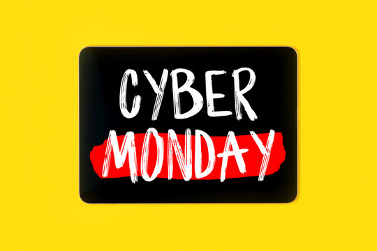 Cyber Monday sign on digital tablet on bright yellow background. Shopping concept