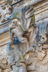 Ancient big statute of scary, fearful and heavy armed gatekeeper, medieval warrior with weapon in historical downtown of Dresden, Germany, details, closeup. Authentic European old architecture.