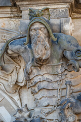 Ancient big statute of scary, fearful and heavy armed gatekeeper, medieval warrior with weapon in historical downtown of Dresden, Germany, details, closeup. Authentic European old architecture.