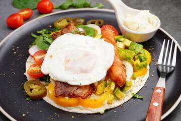 kebab with bacon and fried egg, tomato, spinach, avocado, pickled peppers
and sauce delicious on the plate