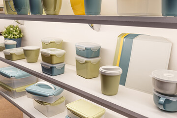 Industrial background with plastic products. Various containers for storing food on the shelf for sale in the store. Kitchen interier