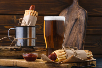 French hot dog with beer in rustic style. Street food.