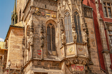 Colorful ancient painted houses, towers with drawings and sculptures at old historical and touristic downtown in Prague, Czech Republic, details, closeup. Cityscape of Medieval Prague.