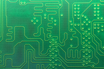 Close up of a used printed green electronic circuit board with dust