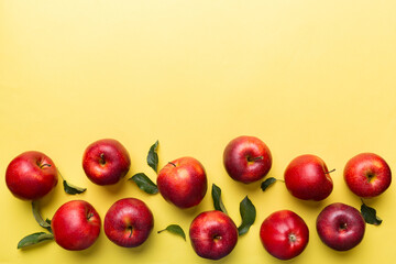 Many red apples on colored background, top view. Autumn pattern with fresh apple above view with copy space for design or text