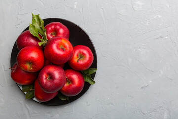 Many red apples on cement background, top view. Autumn pattern with fresh apple above view