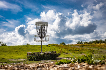 white disc golf basket at the sunny course in Finland