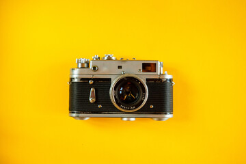 Fototapeta premium Vintage Photo Camera on yellow background