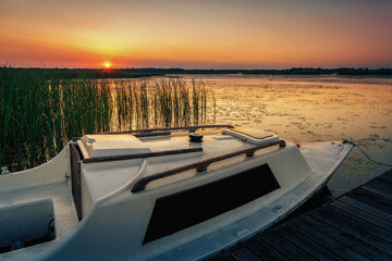Fototapeta na wymiar sunset on the lake and boat in wytyckie lake, poland lubelskie