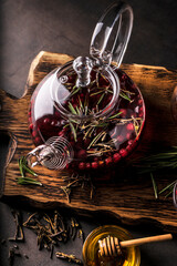 selective focus, freshly brewed tea in a transparent teapot, with fruits and fresh berries. leaf tea and spices. still-life. for advertising and menus