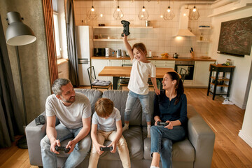 Excited little girl celebrate win playing video game © Svitlana
