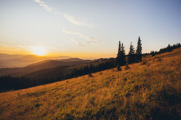 panorama of sunset in the mountains. sunbeams. rest on mountain tops. rays of the sun