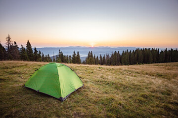 vacation in the mountains. dawn on top of the mountain. tent. Sunrise