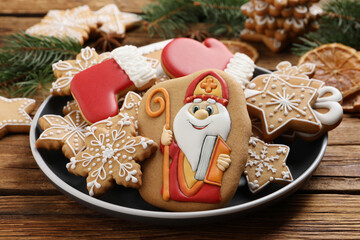 Tasty gingerbread cookies on wooden table, closeup. St. Nicholas Day celebration