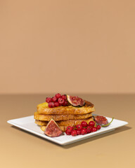 Traditional French toast with figs and red currants. Fried bread soaked in a mixture of milk, eggs and sugar.