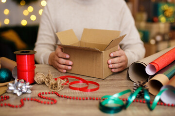 Close up of man's hands wrapping christmas presents