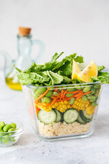 Glass box with fresh raw vegetable salad. Healthy Meal recipe preparation. Healthy vegan dishes in glass container. Vegetarian cuisine. Plant-based dishes. Green living concept. Organic food.