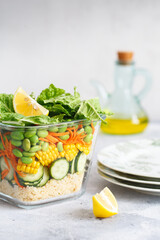 Glass box with fresh raw vegetable salad. Healthy Meal recipe preparation. Healthy vegan dishes in glass container. Vegetarian cuisine. Plant-based dishes. Green living concept. Organic food.