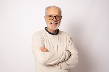 Portrait of senior man with crossed arms isolated on white