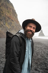 Male person looking at camera with cheery face while traveling at the Iceland