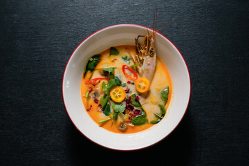 Tom yum is a spicy and sour soup with chicken or fish or shrimp or other seafood. National dish of Laos and Thailand.
