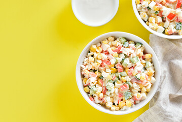 Salad with crab sticks, corn, eggs, cucumber and rice