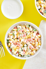 Salad with crab sticks, corn, eggs, cucumber and rice