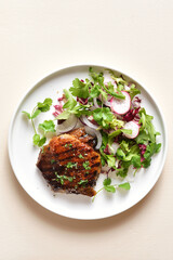 Roasted pork steak with salad from fresh vegetable