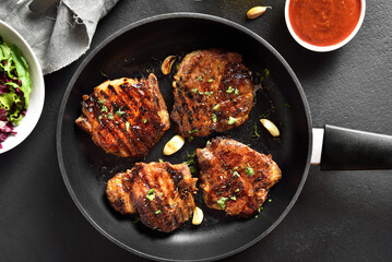 Pork steaks in frying pan
