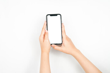 holding a smartphone using two hands. a smartphone with a blank white screen used for advertising mockup.