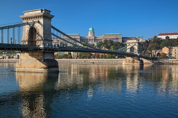 Fototapeta na wymiar Budapest, Hungary. Szechenyi Chain Bridge across Danube and Royal Palace in Buda Castle in sunny autumn morning.