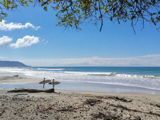 Sufers on the beach of Santa Teresa, Costa Rica.