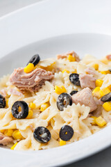 pasta farfalle with tuna, black olives and corn